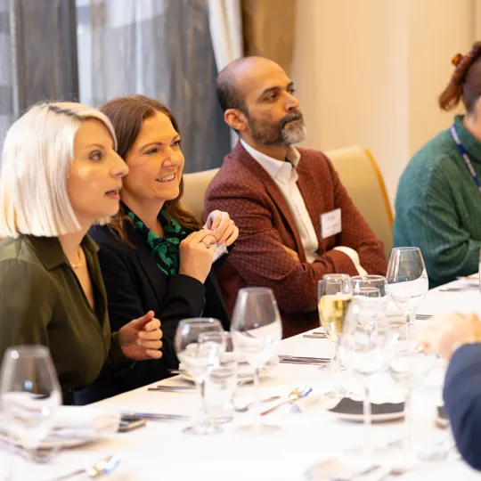 guests sat at a table smiling